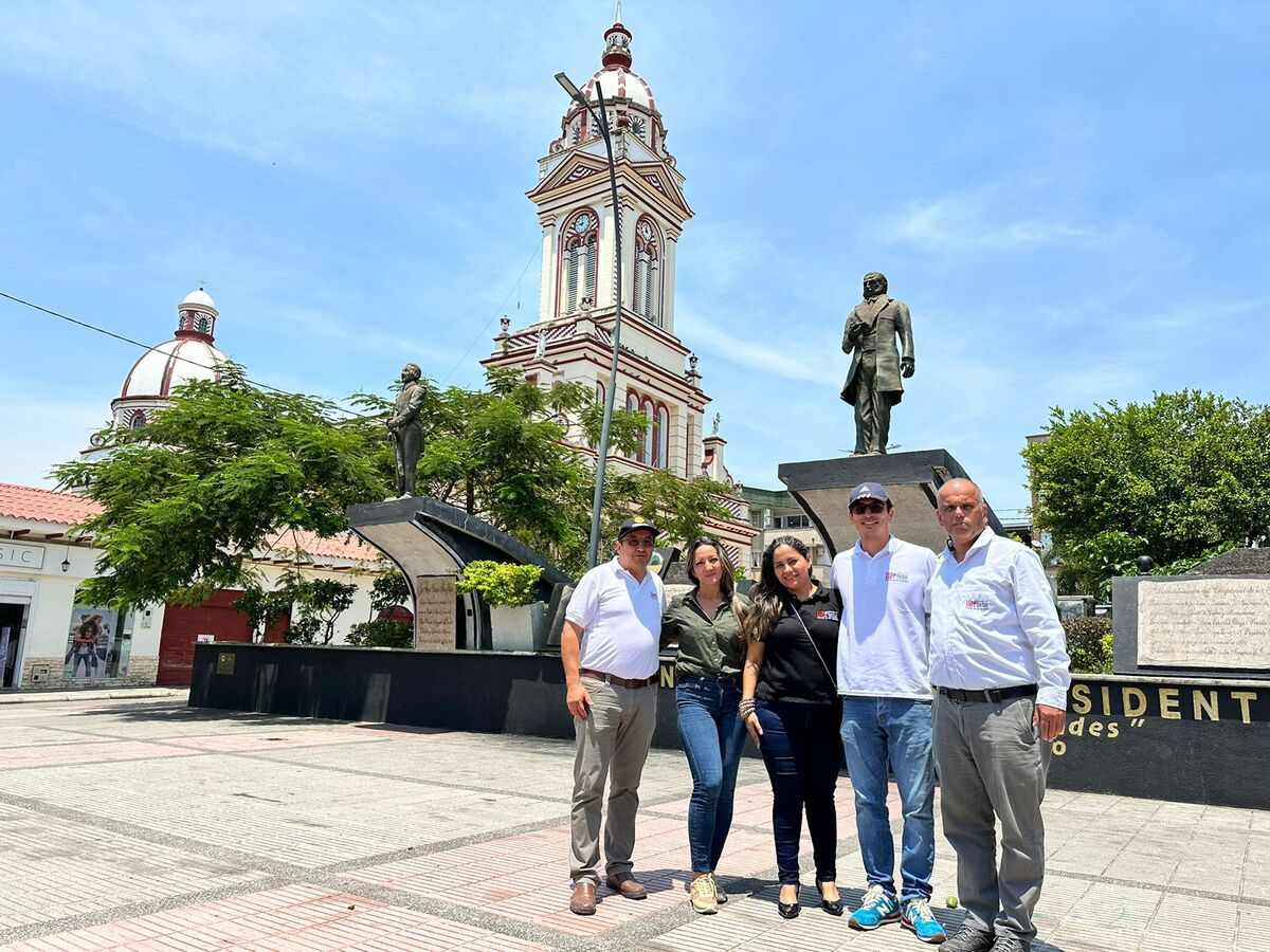 Una fotografía que muestra al equipo académico de la Universidad Piloto de Colombia, Seccional del Alto Magdalena, posando en el parque central de Chaparral, Tolima con la iglesia de fondo.